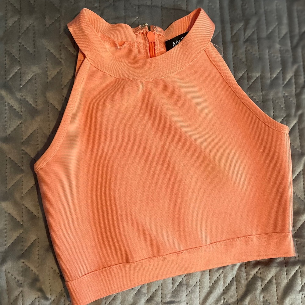 Coral mini top , paired with gold skirt
